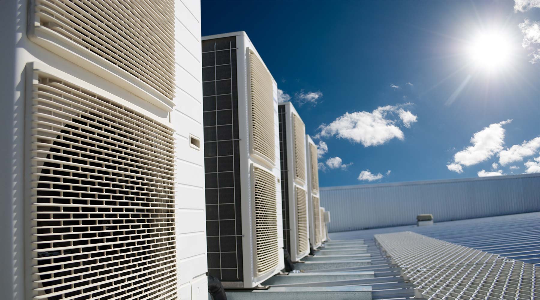 Air conditioner units with sun and blue sky